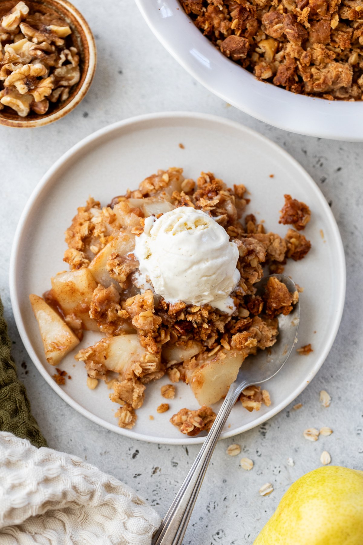 Pear crisp recipe on plate with vanilla ice cream