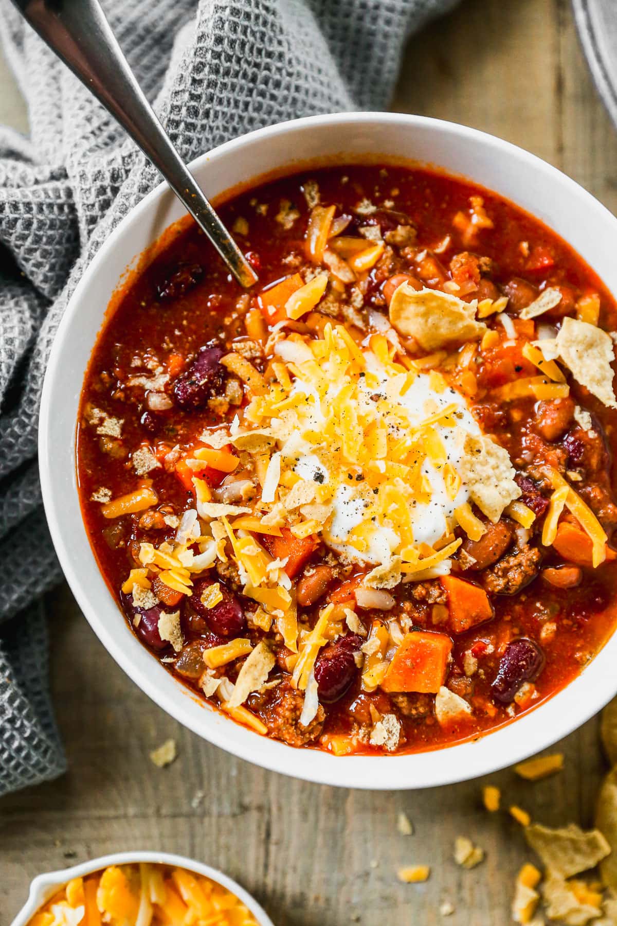 Instant Pot chili in bowl topped with sour cream and cheese